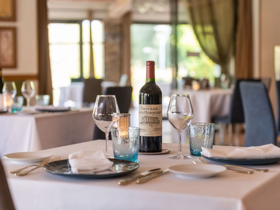 Wine bottle & glasses on a table at Golf Chateau de la Begude