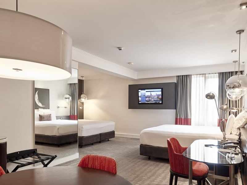 King and queen beds in Deluxe Suite with carpeted floors at Pullman Albert Park