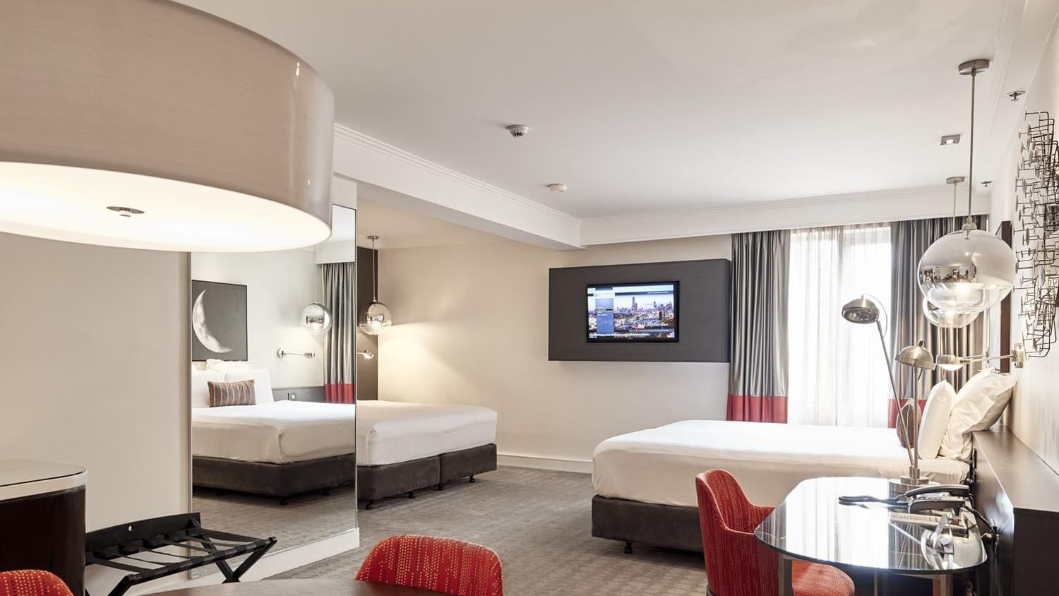 King and queen beds in Deluxe Suite with carpeted floors at Pullman Albert Park