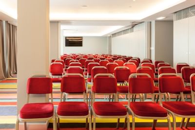 Theatre set-up in Sala III-IV with carpeted floors at Hotel Presidente Luanda