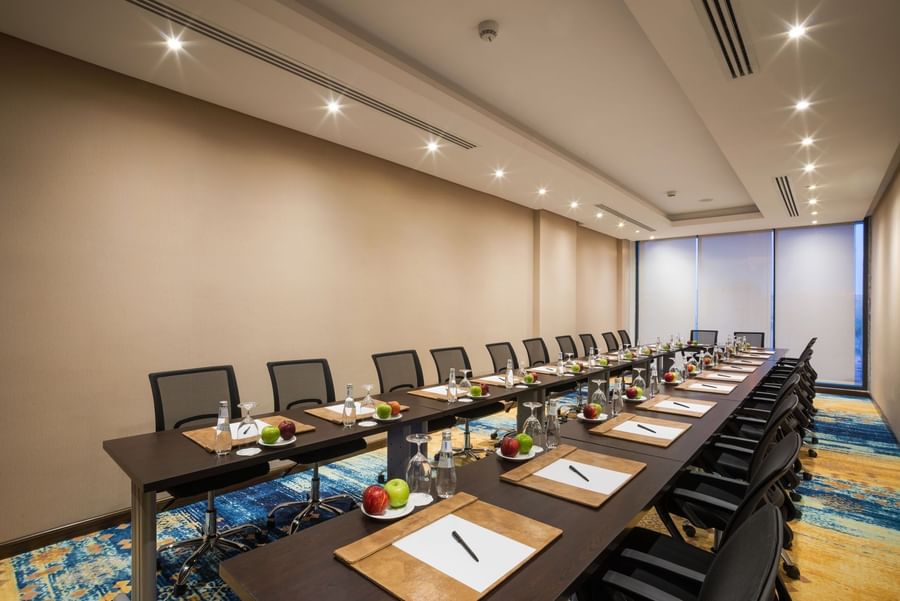 U-shape conference setup with mesh chairs in Khalej Meeting Room at Naviti by Warwick Dammam