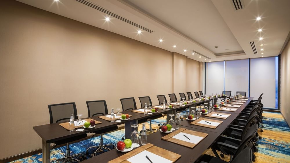 U-shape conference setup with mesh chairs in Khalej Meeting Room at Naviti by Warwick Dammam