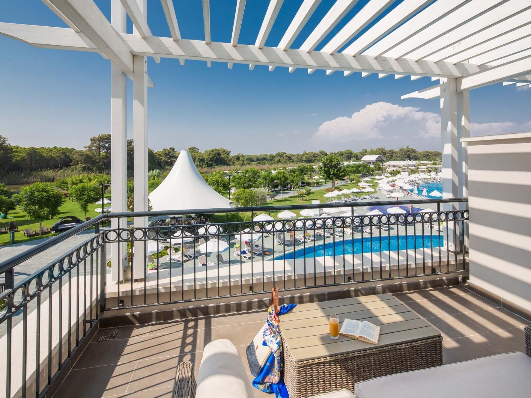 Family Pool Suite Balcony overlooking the pool & lush greenery at Titanic Deluxe Golf Belek