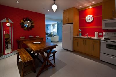 Kitchen area with dining table in Apartment 202 at Retro Suites Hotel