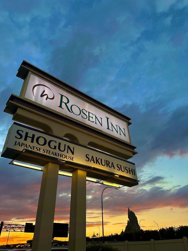 A glowing sign for Rosen Inn and Shogun at twilight. Make our hotel your destination when looking for things to do with teens in Orlando besides theme parks.
