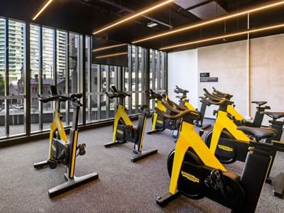 Exercise bikes inside a gym area for spin class at West Tower, Melbourne Quarter.