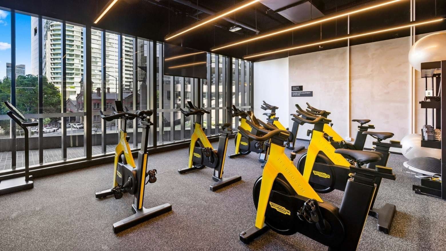 Exercise bikes inside a gym area for spin class at West Tower, Melbourne Quarter.