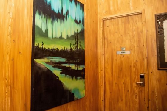 A serene forest painting with a green aurora at Retro Suites Hotel