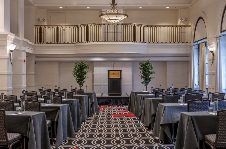 Classroom setup facing the podium in Buckingham Ballroom at Warwick Allerton Chicago