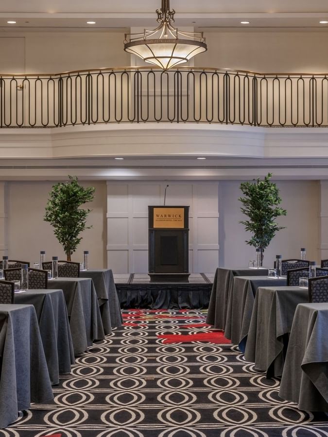 Classroom setup facing the podium in Buckingham Ballroom at Warwick Allerton Chicago