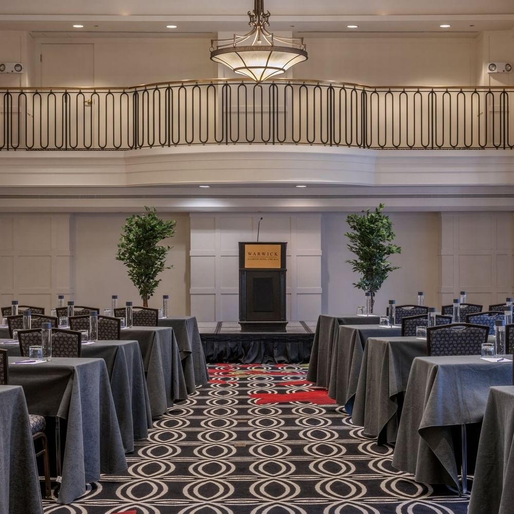 Classroom setup facing the podium in Buckingham Ballroom at Warwick Allerton Chicago