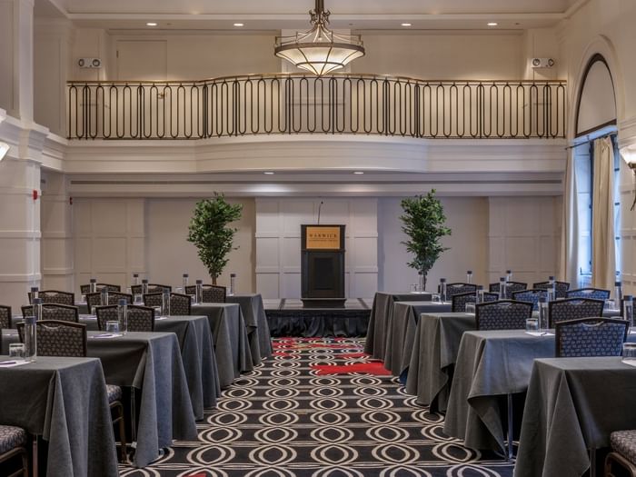 Classroom setup facing the podium in Buckingham Ballroom at Warwick Allerton Chicago