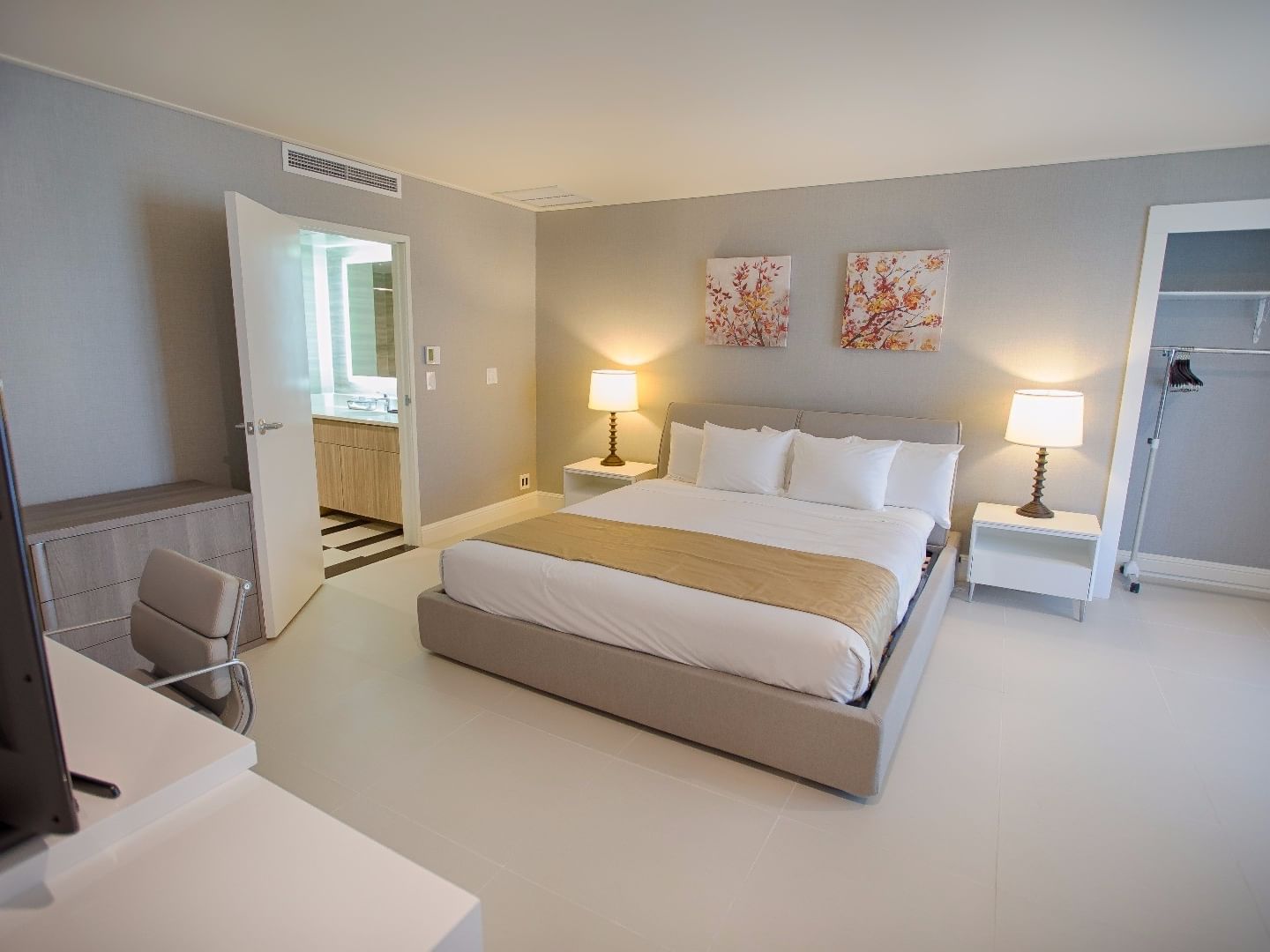 Executive Studio Suite with Kitchenette featuring a king bed, nightstands with lamps, and open closet at Polynesian Residences