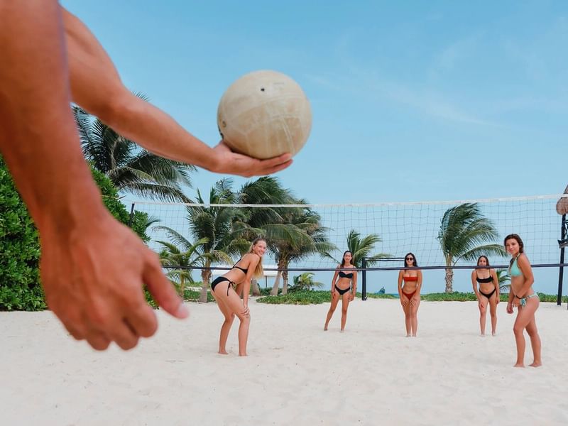 Group of friends playing volleyball at The Reef Coco Beach