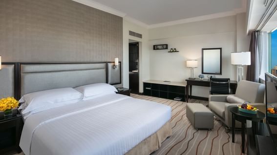 Deluxe Room with a comfy bed, armchair, desk & city view at Park Hotel Group