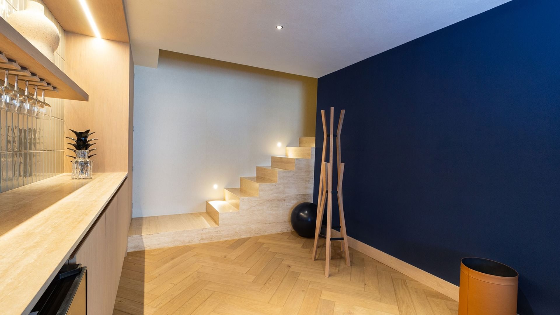 King Superior Viceroys Suite interior stairs with a navy blue accent wall and wood floors at Camino Real Polanco Mexico