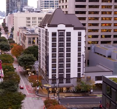The classic facade of The Paramount Hotel Seattle rising above the street in the heart of downtown Seattle
