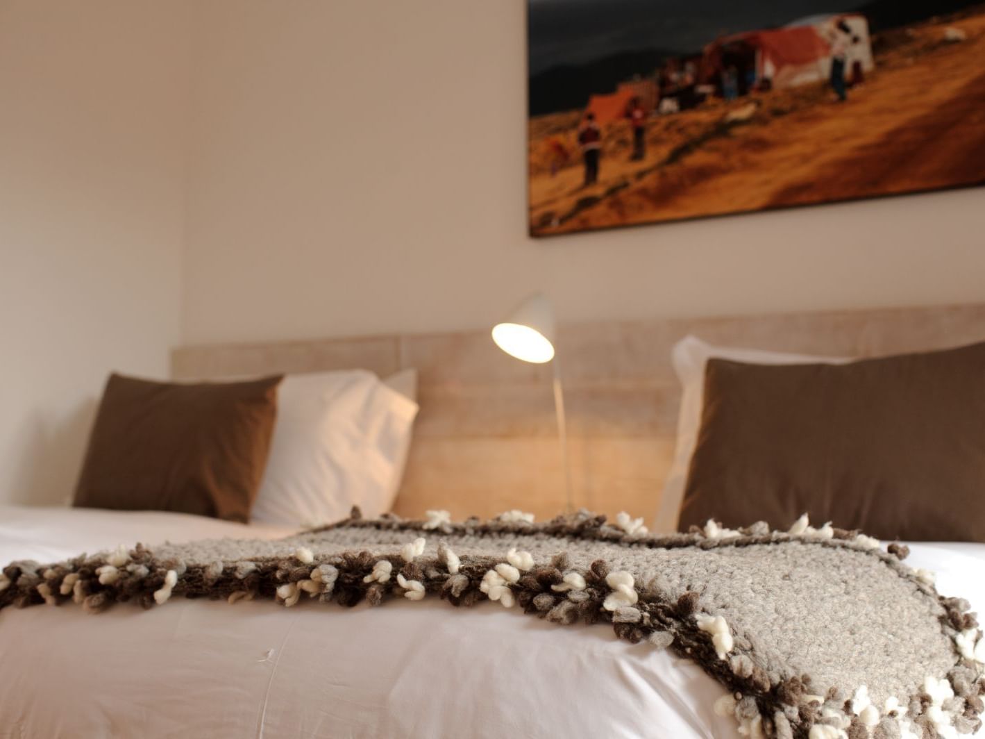 Suite room with queen bed & picture at NOI Casa Atacama hotel
