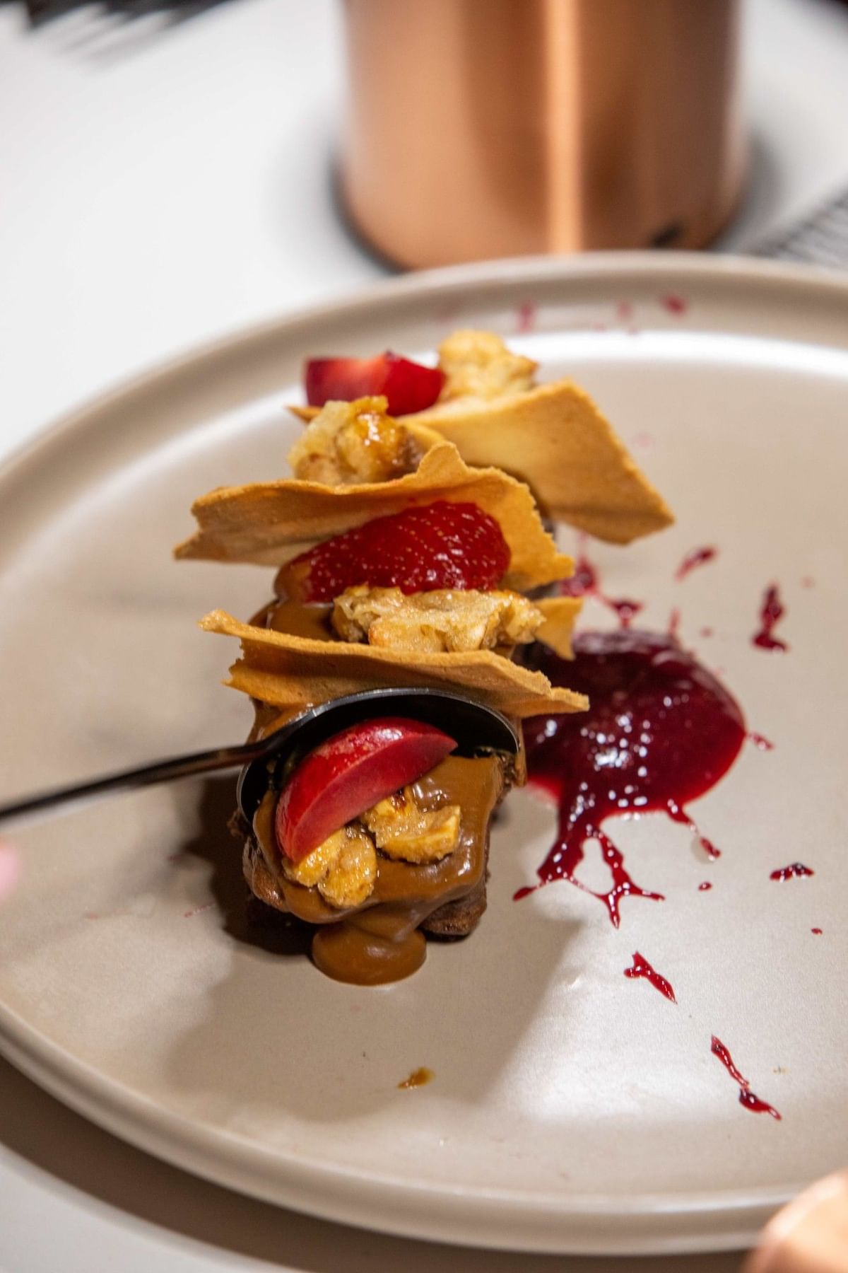 Elegant gourmet dessert featuring fresh berries and crisp wafers on a neutral plate served at Cala Luna Boutique Hotel