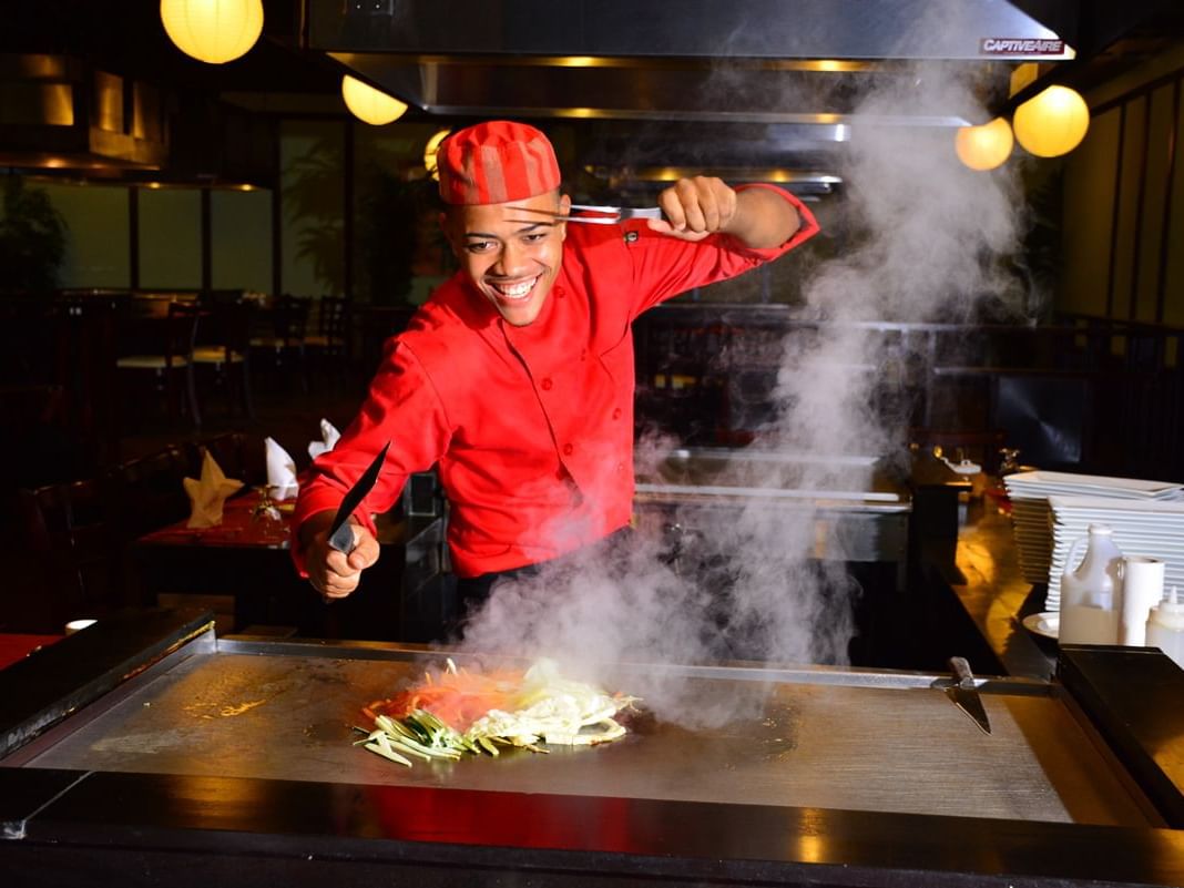 Chef preparing a dish in Kenko Japanese Restaurant at Holiday Inn Montego Bay