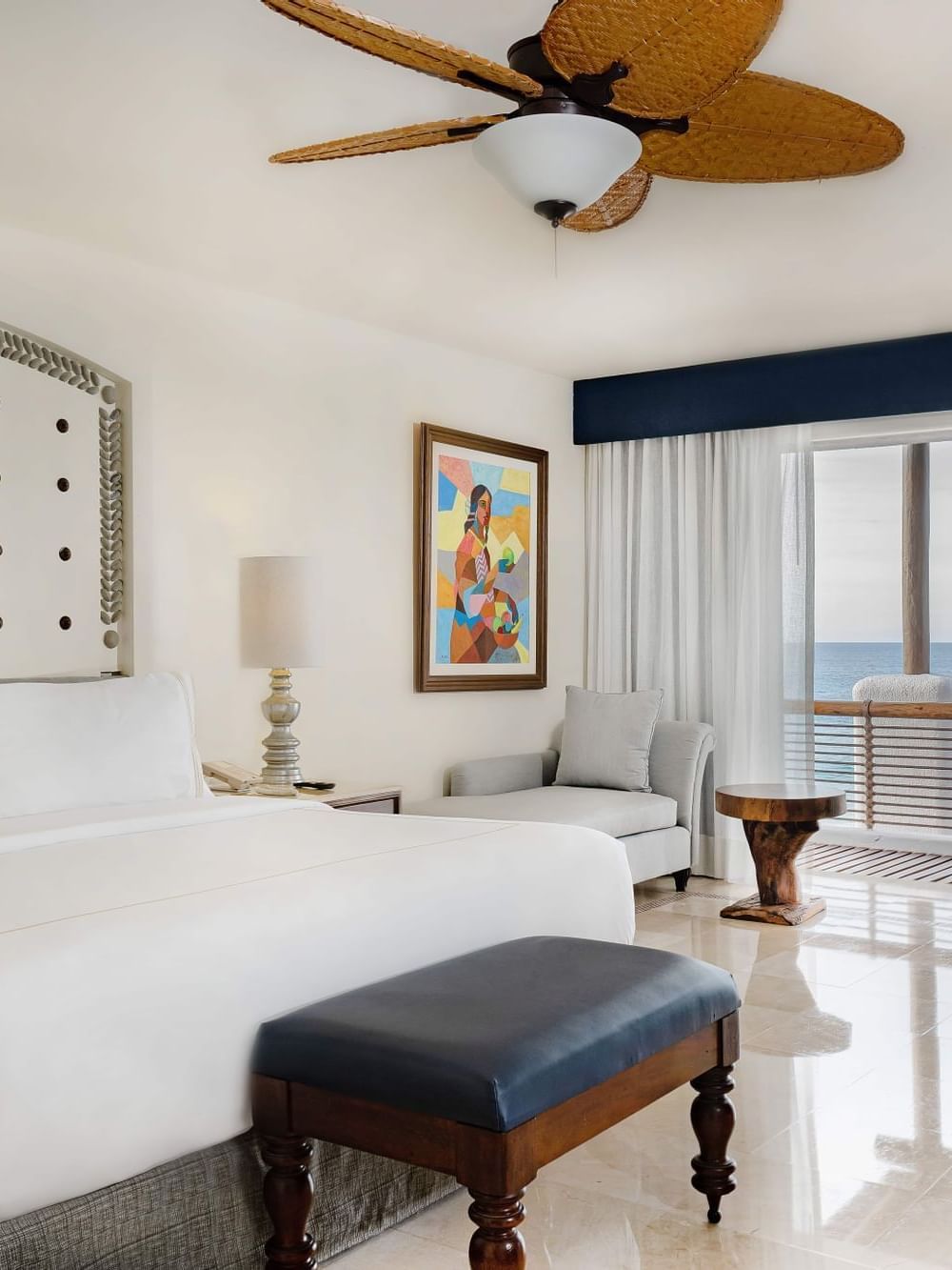 Casita Ocean Front room featuring a comfy bed, couch and a balcony at Marquis Los Cabos Resort