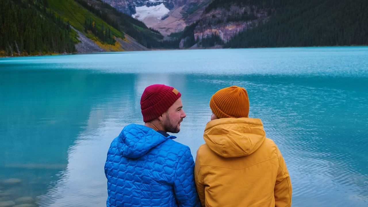 Couple sitting in front of Lake Louise in Alberta