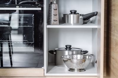 Kitchenette cabinet with dishes in a room at Nesuto Docklands
