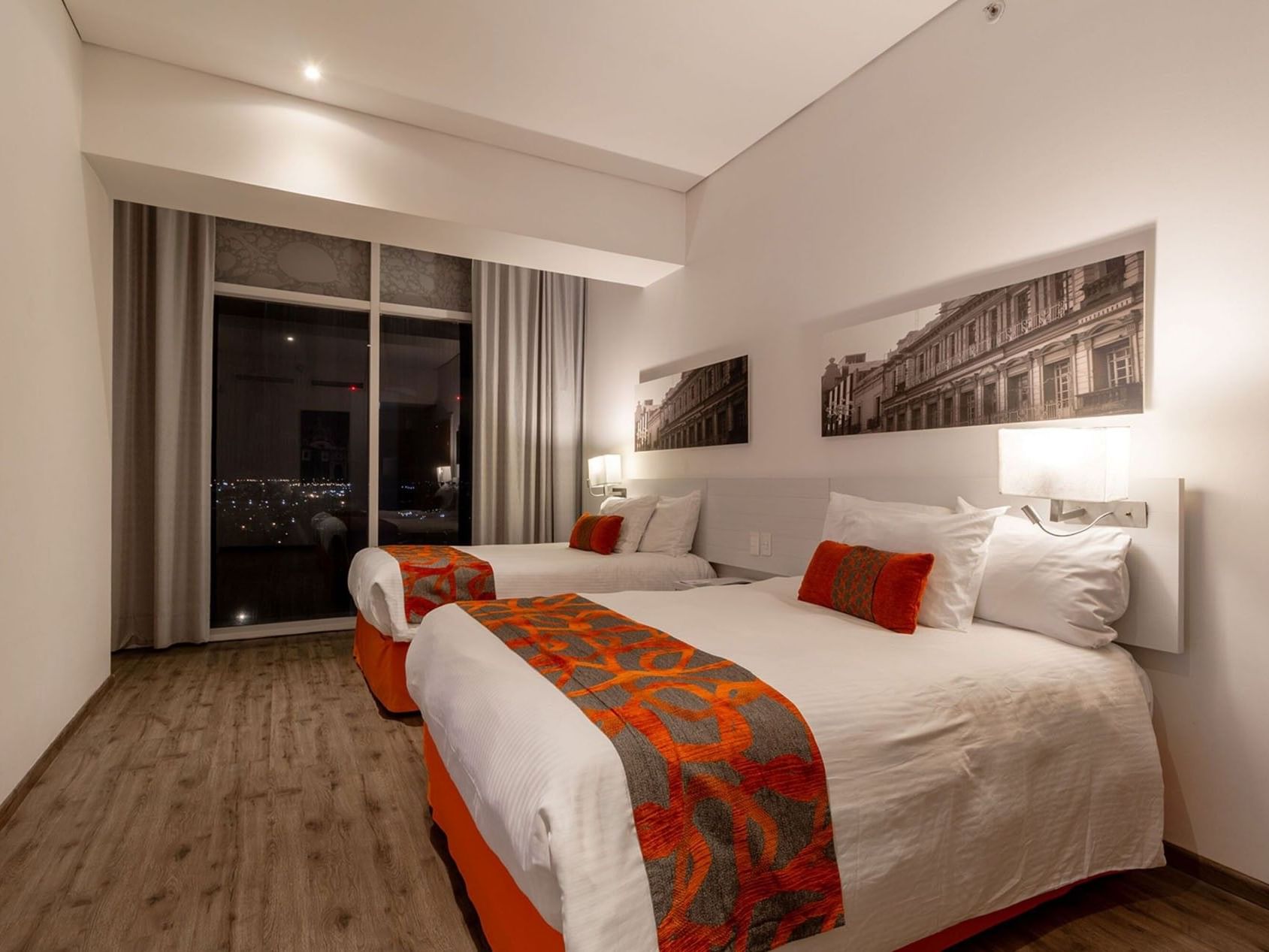 2 Double Suite 1 Room featuring white linens and orange patterned bed runners at Camino Real Puebla Angelopolis