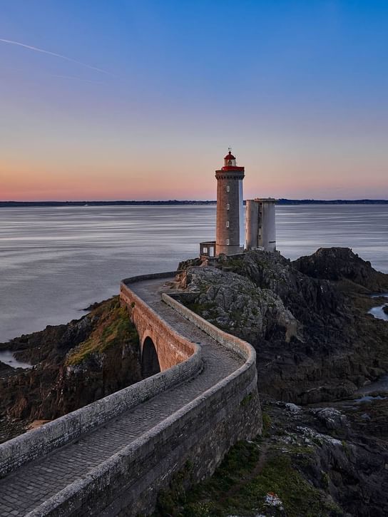 Distant view of Le Phare du Petit Minou with the ocean near Oceania Hotels
