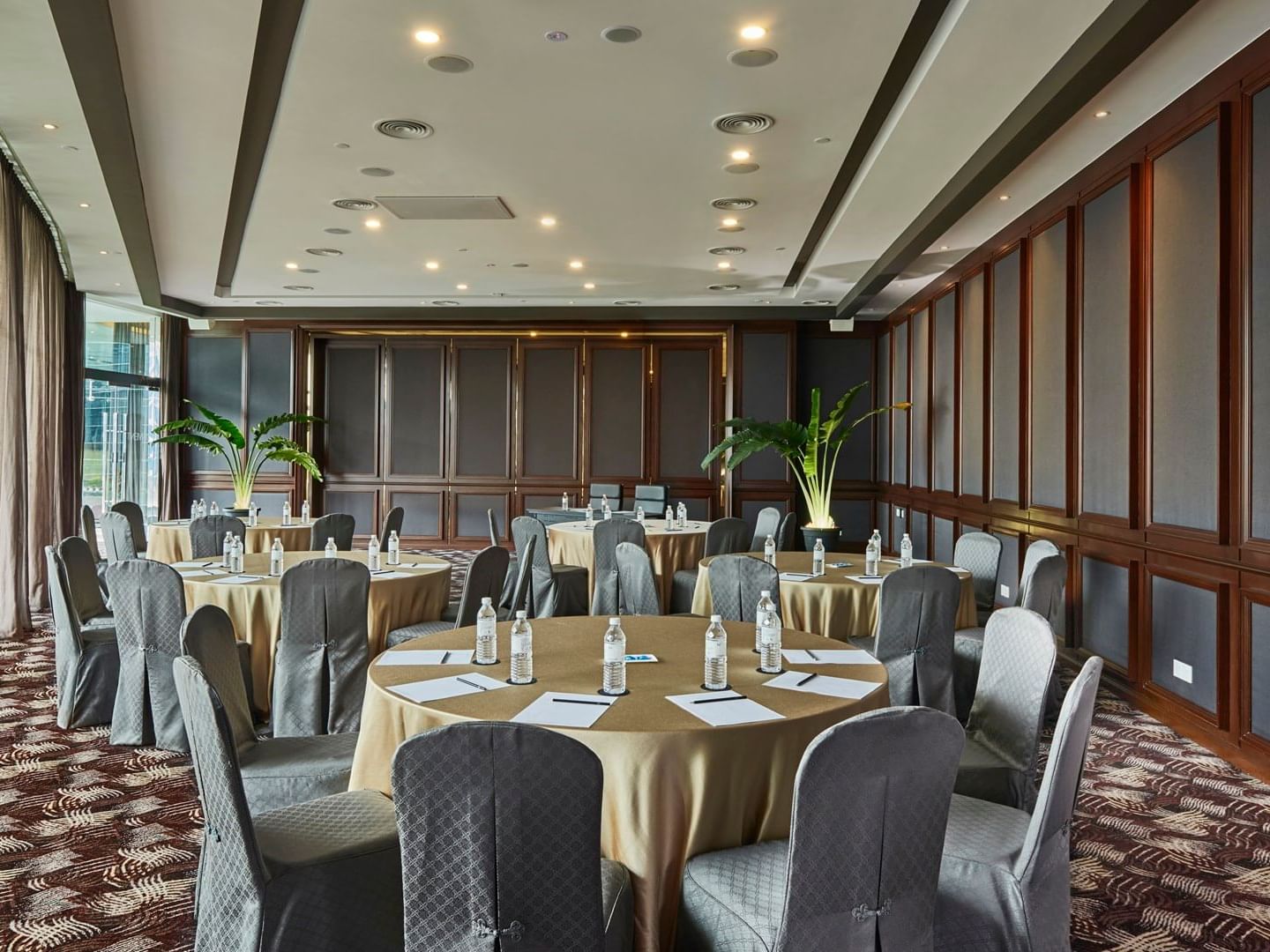 Cabaret set-up in a meeting room with carpeted floors at VE Hotel & Residence