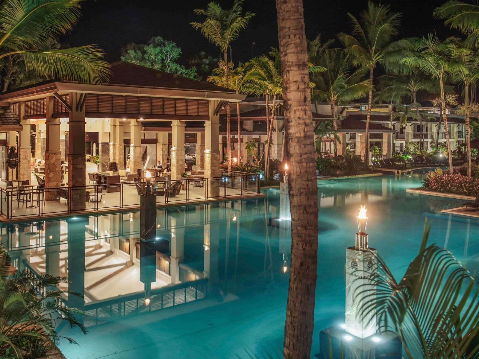 Aluco Restaurant distant night view with outdoor pool at Pullman Port Douglas Sea Temple Resort & Spa