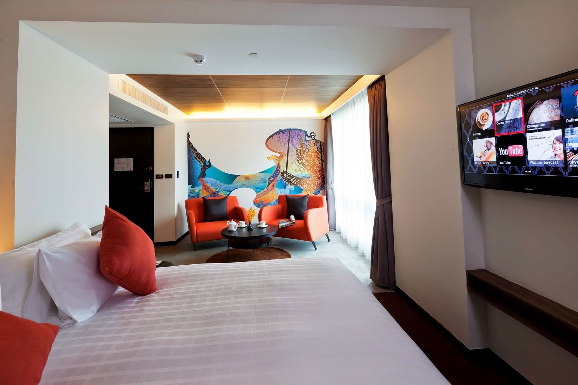 Hotel Bedroom with sitting area, television and a decorative wal