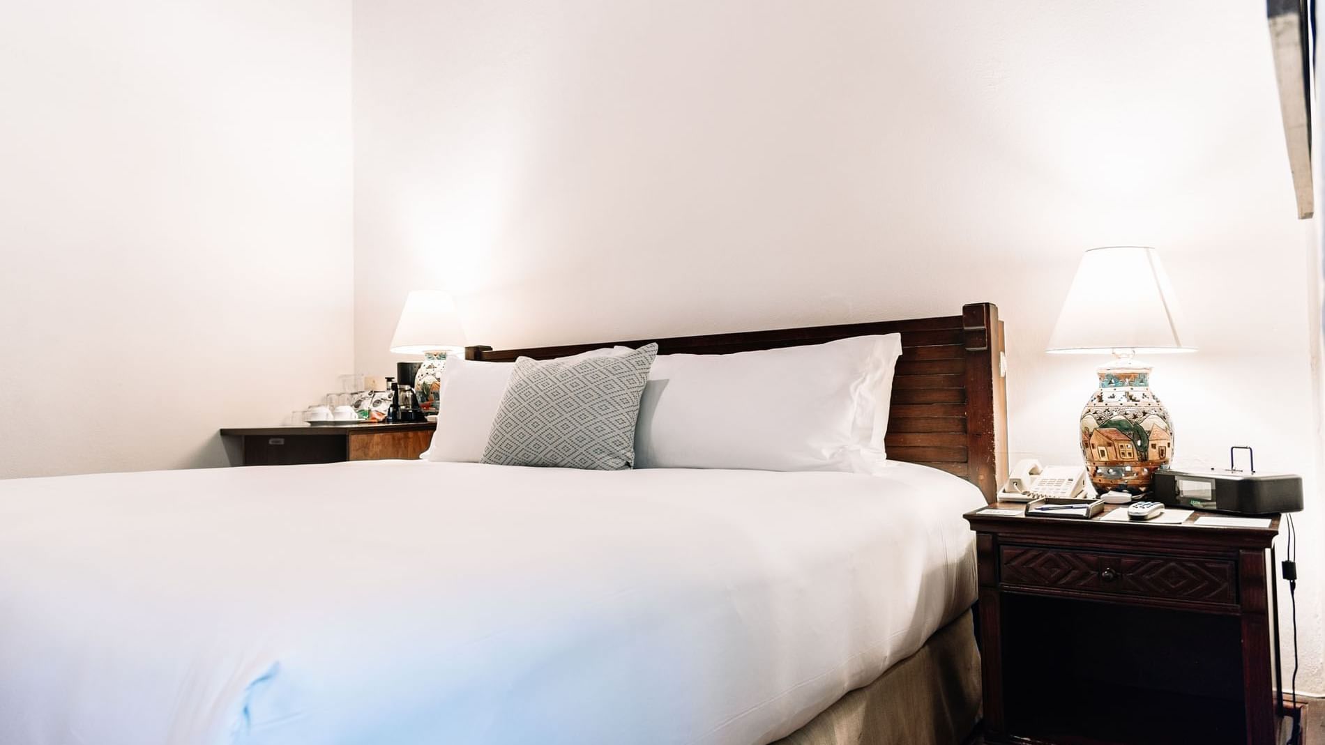 Nightstands with lamps by the cozy bed in the King Novicia Suite at Quinta Real Oaxaca