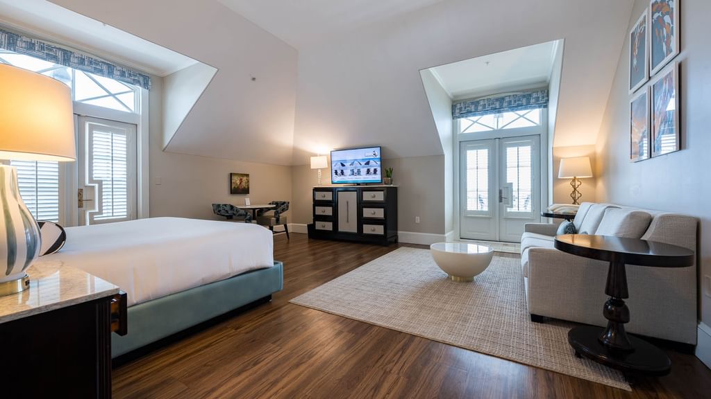 King Bed suite with living area, dining table, and large bed at The Pearl Hotel in Rosemary Beach.