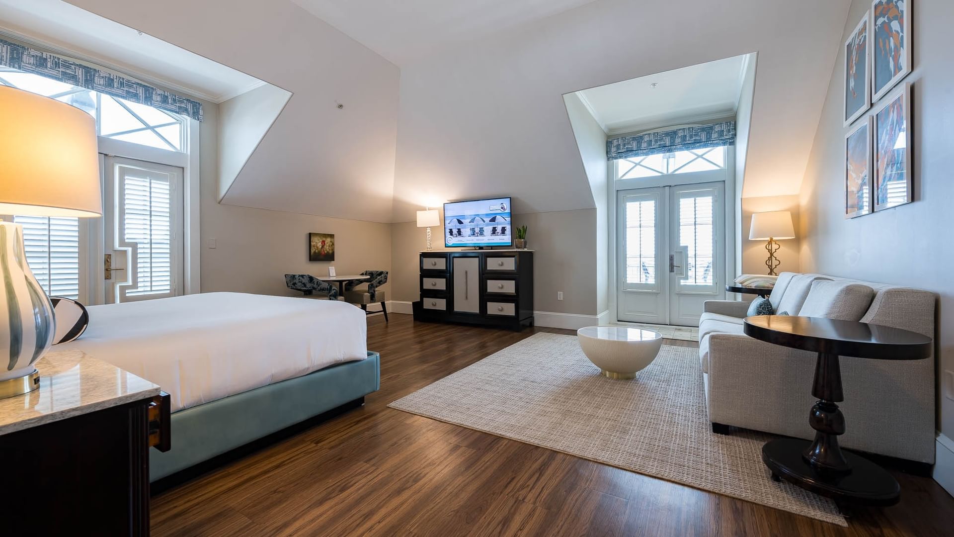 King Bed suite with living area, dining table, and large bed at The Pearl Hotel in Rosemary Beach.