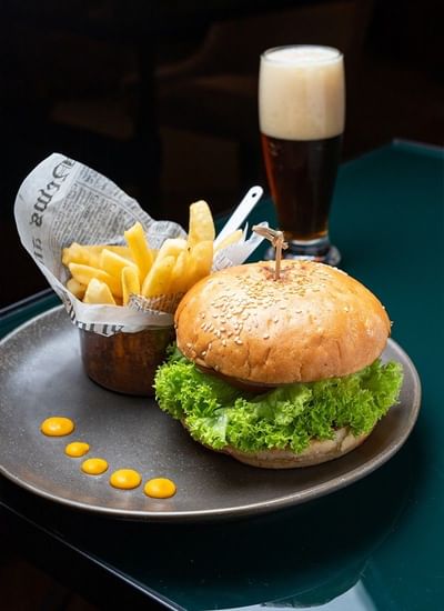Gourmet burger with fries & a drink served at Veranda Restaurant highlighting Valparaiso Chile restaurants in Veranda Hotel
