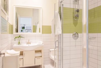 Bathroom interior with shower cubicle & mirror in Queen Premiere Spring Fling at Retro Suites Hotel