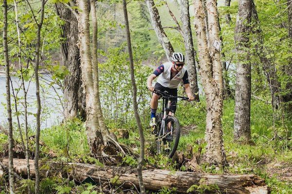 Man mountain biking in the middle of a forest