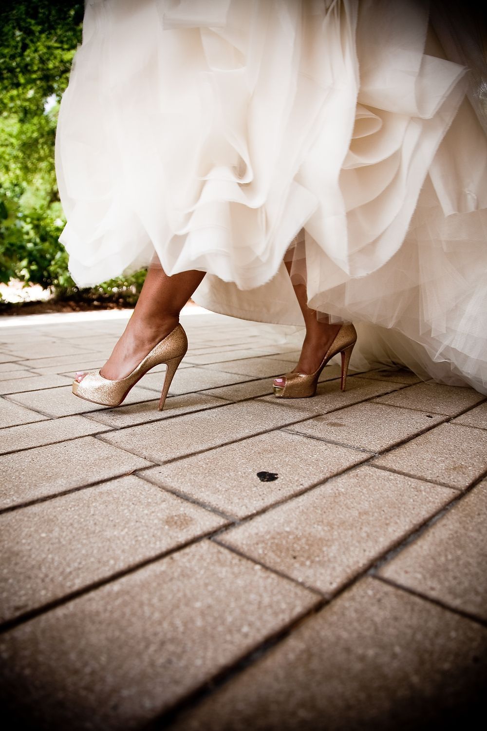 Close-up of gold shoes and wedding dress at Umstead Hotel and Spa