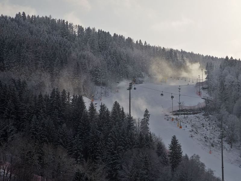 Aerial view of snowy mountain path near Falkensteiner Hotels