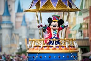 Mickey Mouse character waving from a parade float at a theme park near Lake Buena Vista Resort Village & Spa