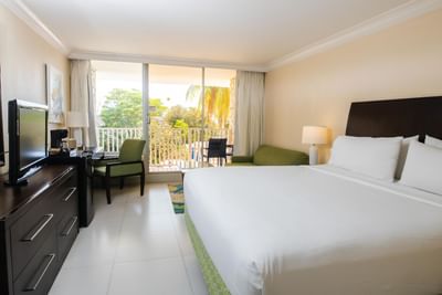 King bed, TV & furniture in a room at Holiday Inn Montego Bay