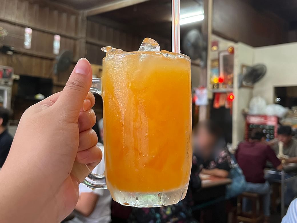 Iced orange juice in a glass mug, a refreshing drink in Yok Keng at Hop Inn Surat Thani