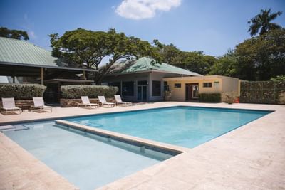Exterior view of the outdoor pool with sun loungers at Cha Cha Hotel