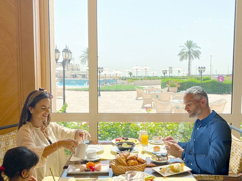 Family enjoying foods in a restaurant at The Regency Hotel