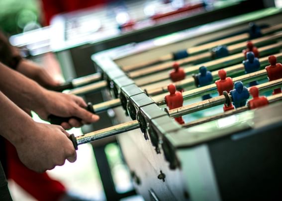 Close-up of people playing table football in the game room at Sebasco Harbor Resort