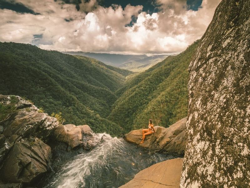 A woman in Windin Falls near Pullman Palm Cove Sea Resort