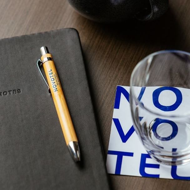 Book, pen, cup & mug on a meeting table, Novotel Glen Waverley