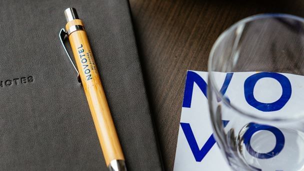 Book, pen, cup & mug on a meeting table, Novotel Glen Waverley