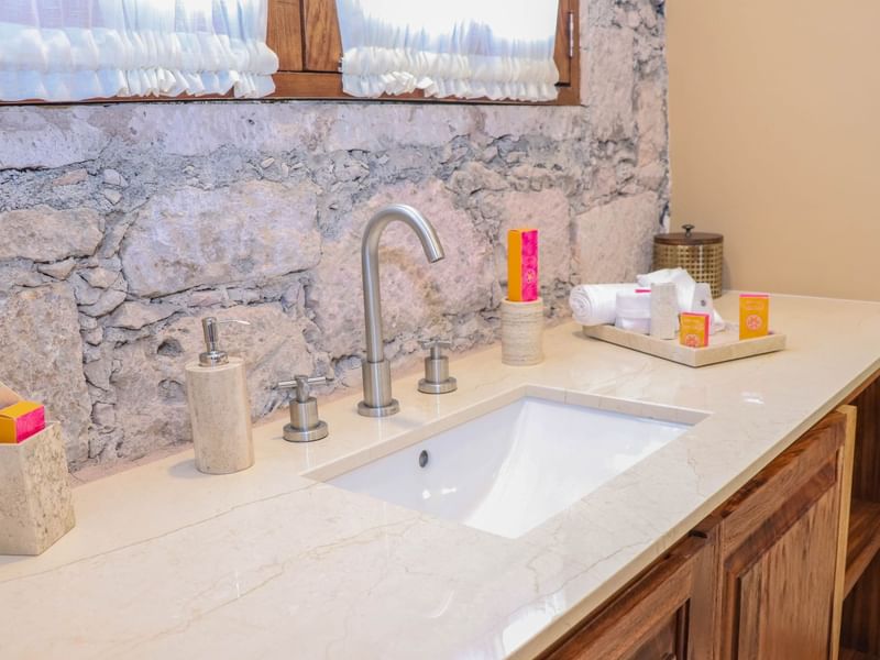 Bathroom vanity area in Deluxe Room at Gamma Hotels